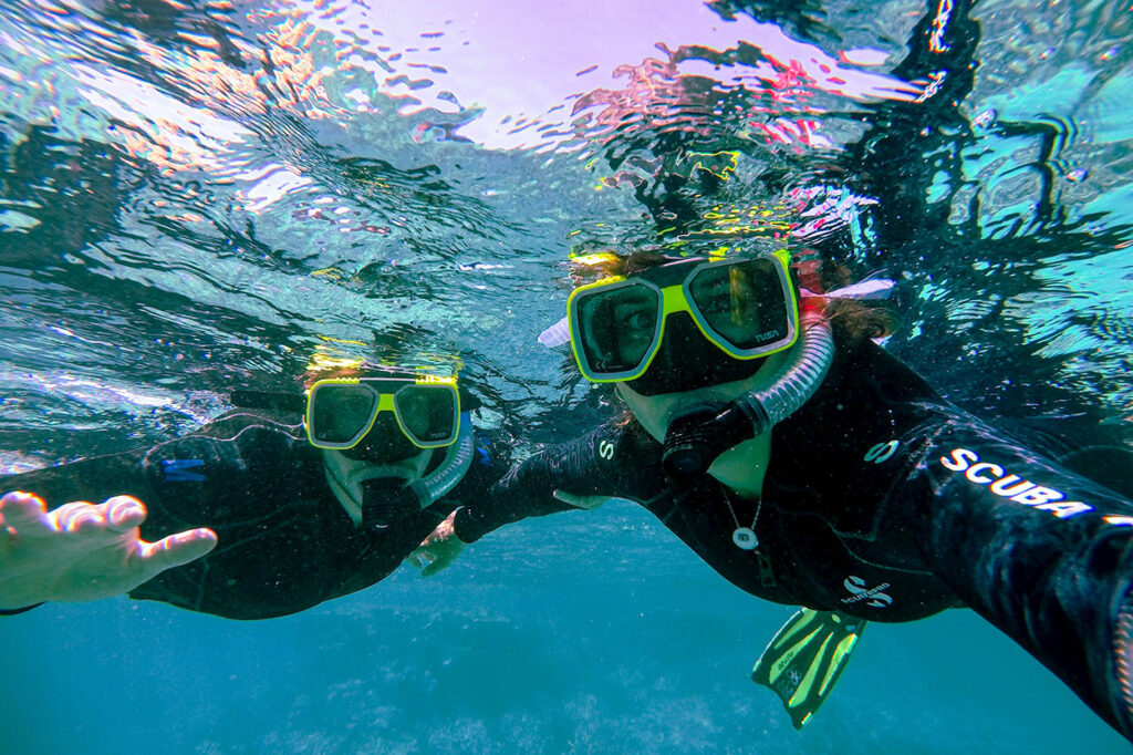 couple snorkeling at Malmok Beach, which beach is best in Aruba?
